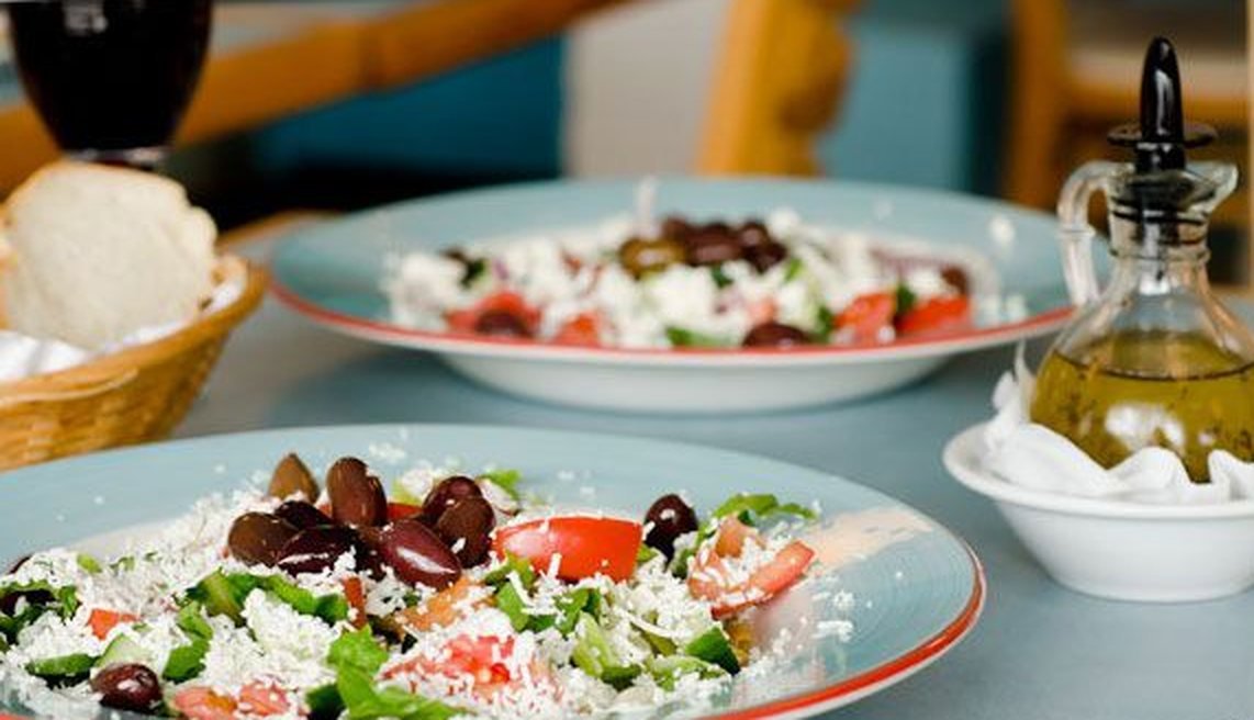 Greek salads with olive oil and bread