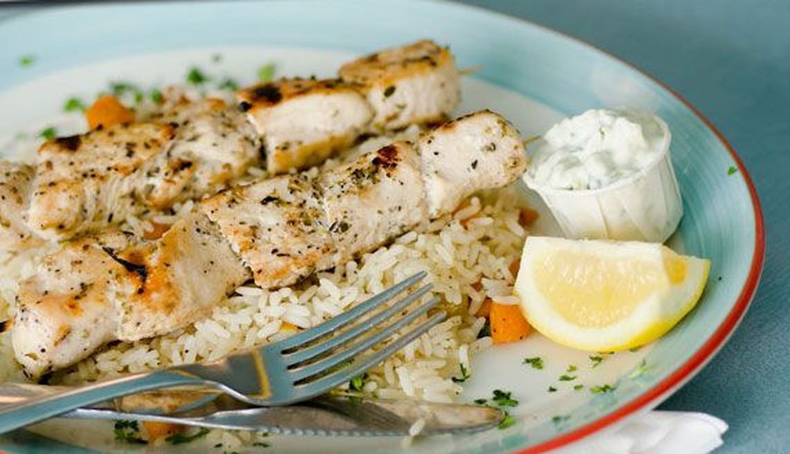 Souvlaki skewers on rice with tzatziki